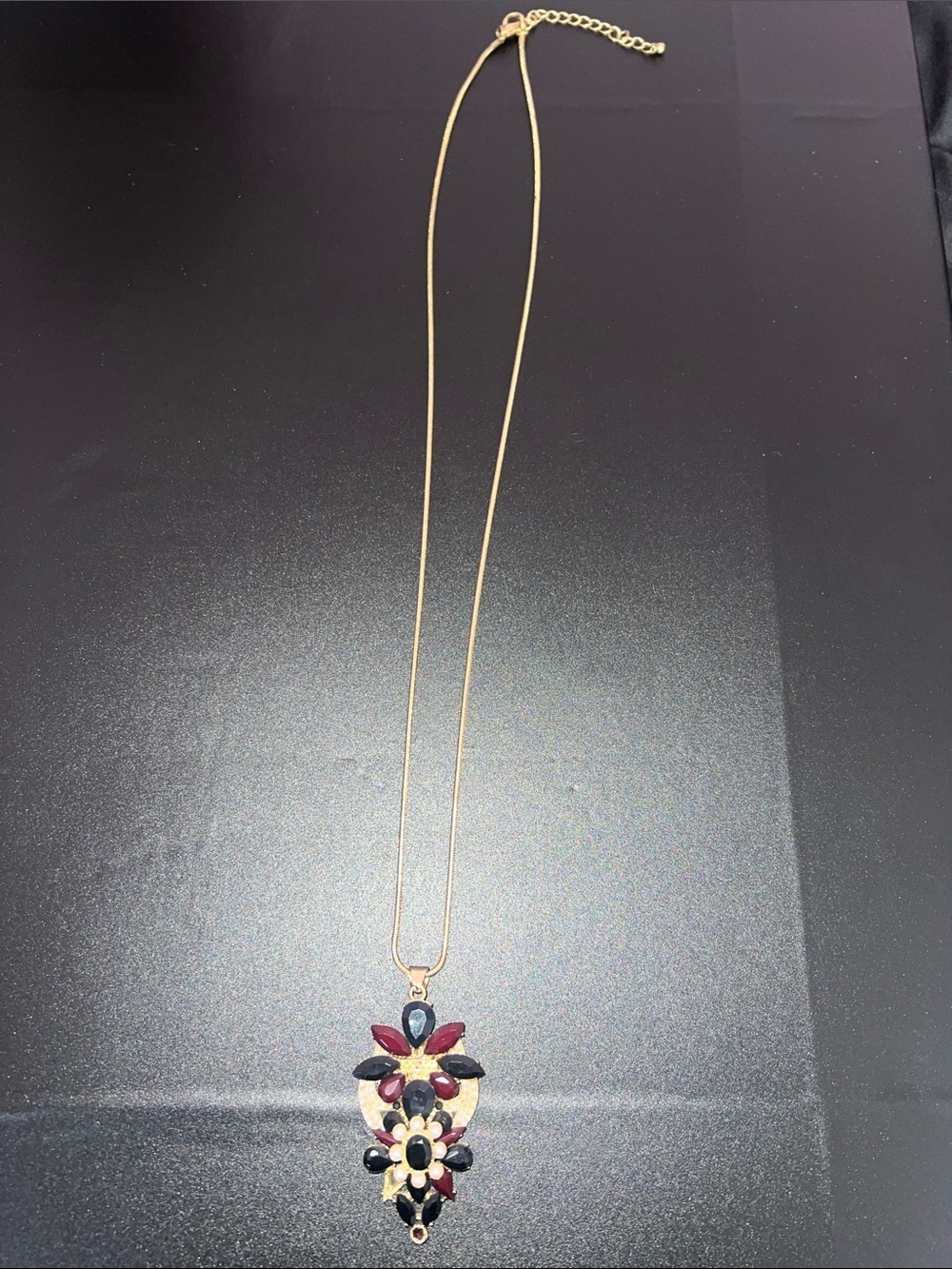 Gold-Tone Floral Pendant Necklace with Red and Black Stones